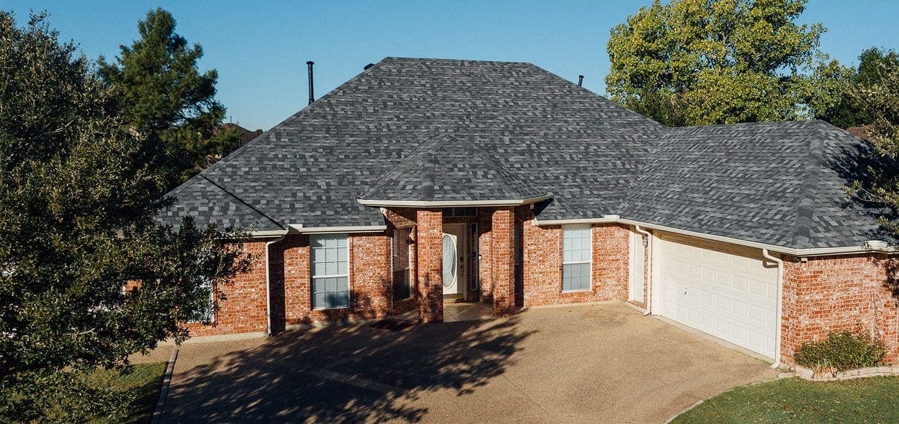 Aerial view of a completed roof on a brick home